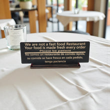 Load image into Gallery viewer, Sign - English &amp; Spanish - With STAND - We are not a fast food restaurant Please Be Patient - 10x4 Inches