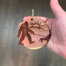 Load image into Gallery viewer, Sasquatch walking his dog - Cedar Ornament